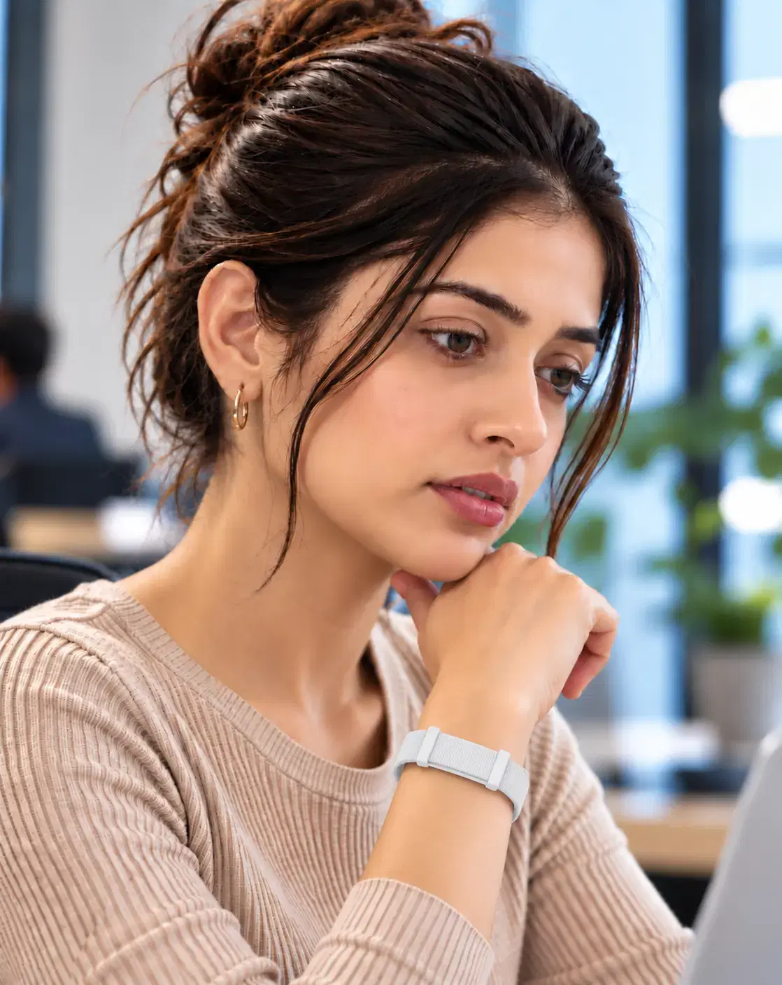 Woman wearing the Make My Health fitness band while working