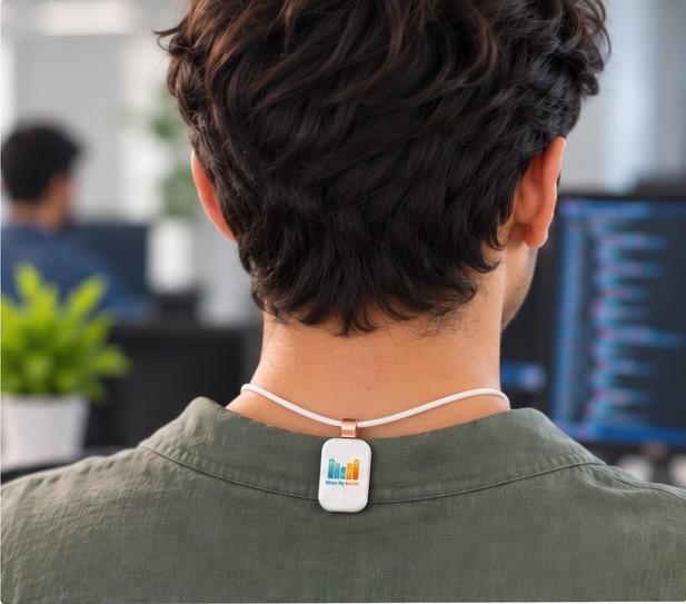 Man at a desk wearing the sensor on his upper back
